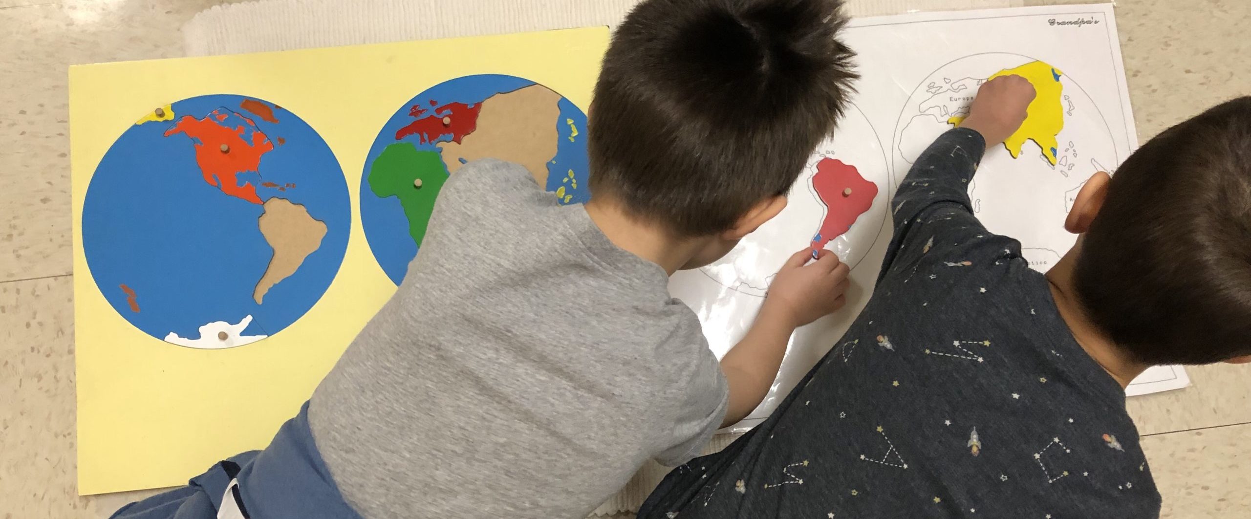 montessori-activity-globe-pair-two-kids-working-scaled-e1602800094595.1f24d94420.jpg